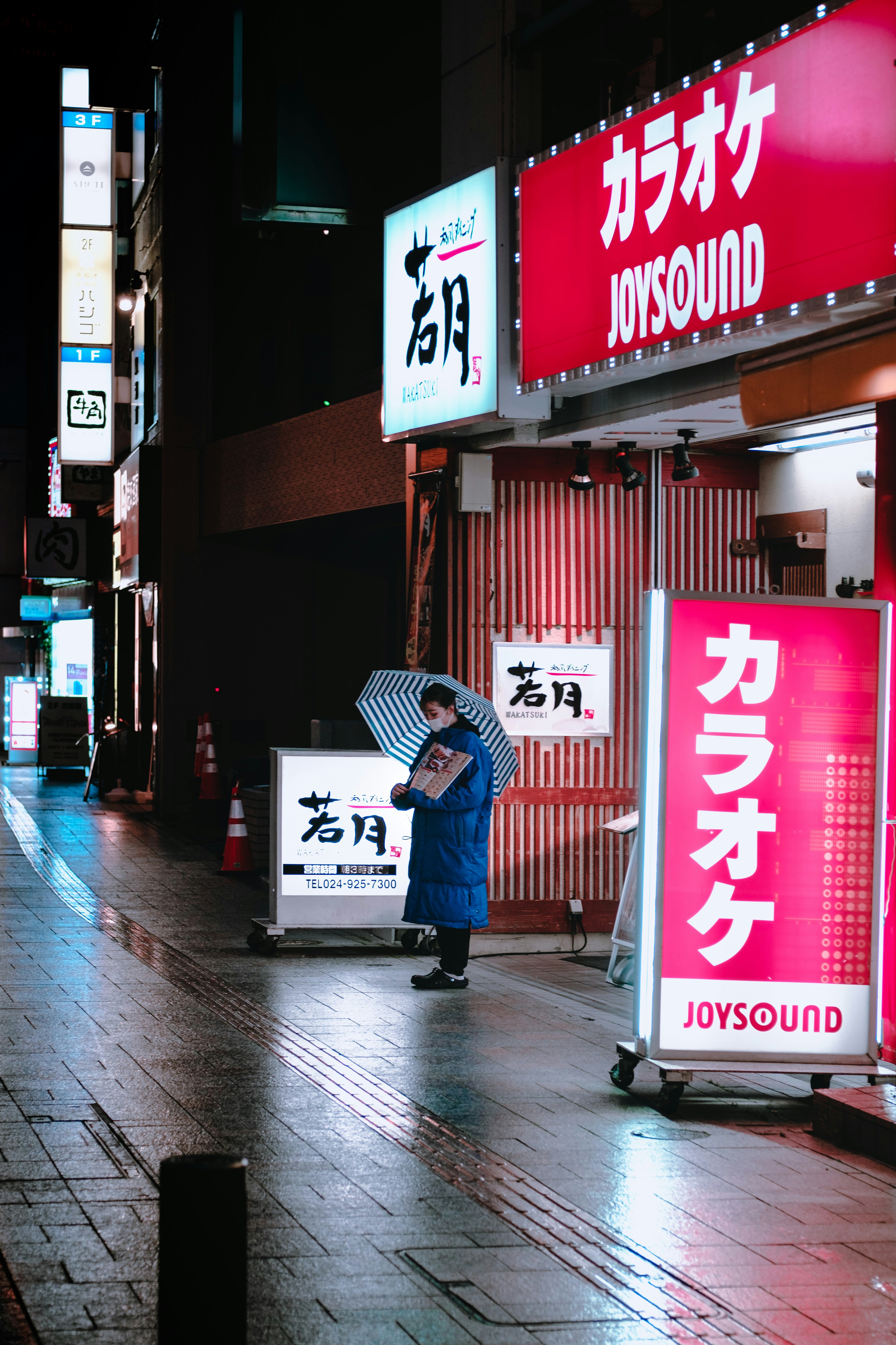 man in blue jacket and blue pants walking on sidewalk